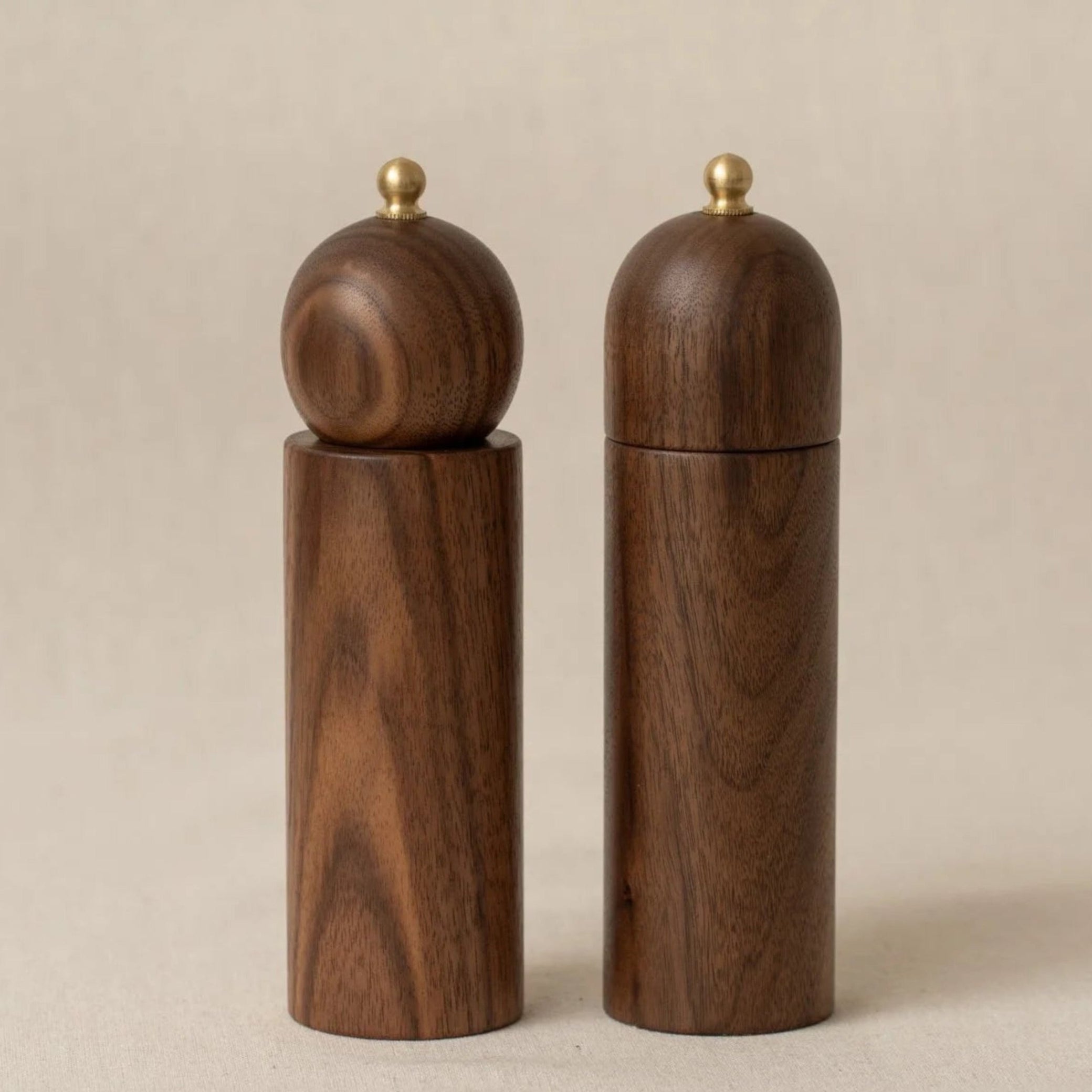 Wooden salt and pepper shakers on a beige background