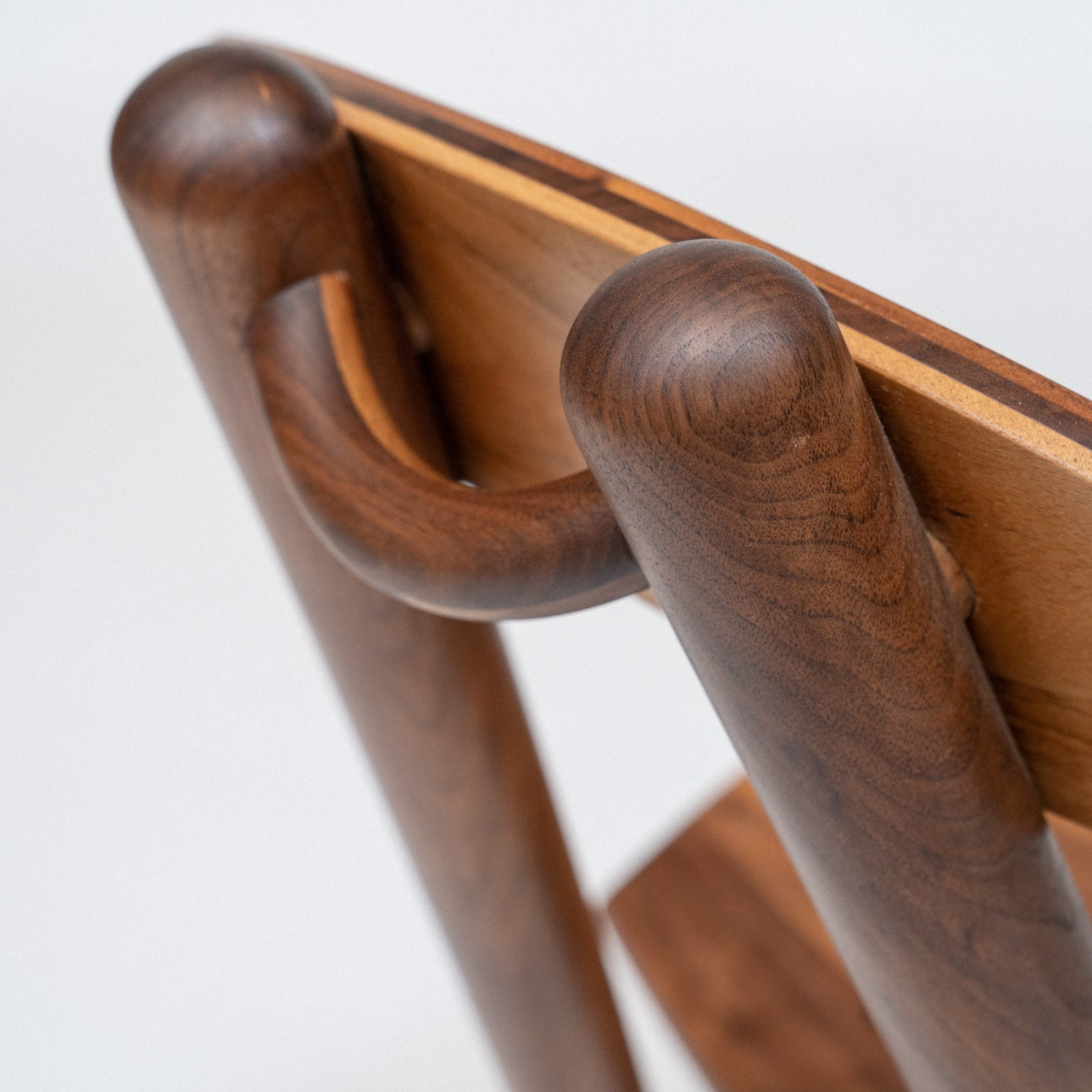 Wooden walnut dining chair with a white background